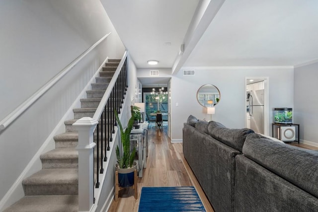 46 Ivy Rdg NE, Atlanta, GA 30342 - stairway featuring wood finished floors, baseboards, ornamental molding, and a chandelier