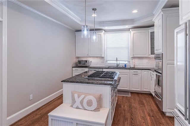 kitchen featuring a sink, dark wood-style flooring, white cabinets, and crown molding