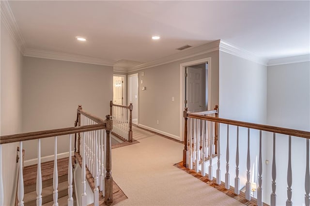 hall featuring crown molding, an upstairs landing, visible vents, and baseboards