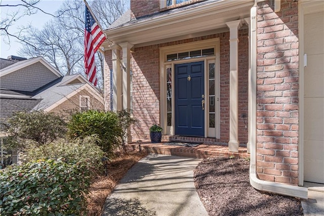 property entrance featuring brick siding