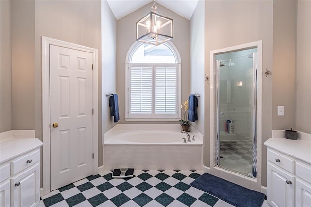 bathroom featuring a shower stall, tile patterned floors, a bath, a notable chandelier, and vanity