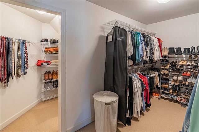 walk in closet with carpet flooring