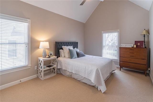 bedroom with multiple windows, light colored carpet, and baseboards