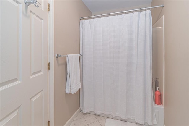 bathroom featuring tile patterned flooring, curtained shower, and baseboards