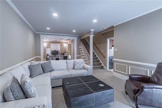 living room with crown molding, stairs, decorative columns, light carpet, and recessed lighting