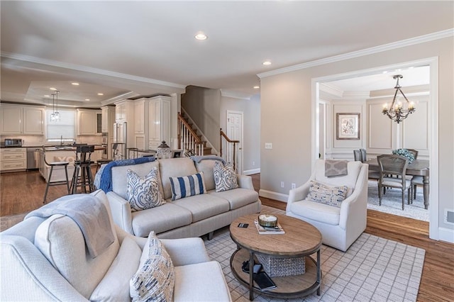 living room with baseboards, dark wood finished floors, stairs, ornamental molding, and recessed lighting