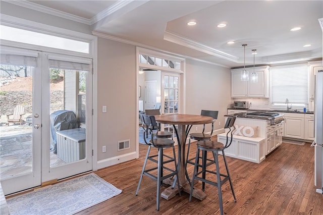 dining room featuring visible vents, ornamental molding, dark wood-style flooring, and french doors