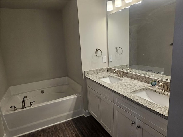 bathroom featuring vanity, a bathtub, and hardwood / wood-style flooring