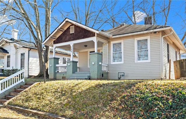 view of front of house with covered porch and a front yard