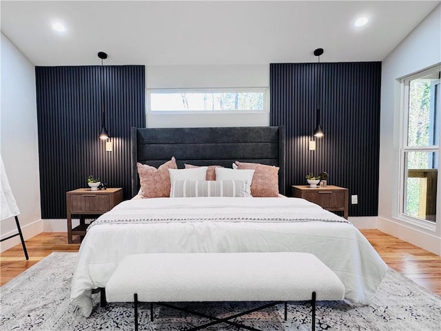 bedroom featuring hardwood / wood-style floors and multiple windows