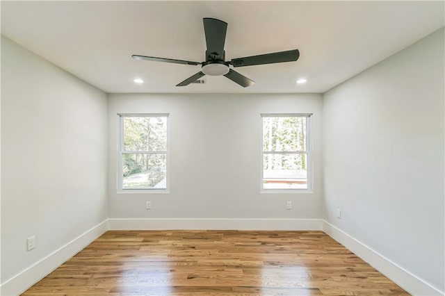 empty room featuring ceiling fan and light hardwood / wood-style floors