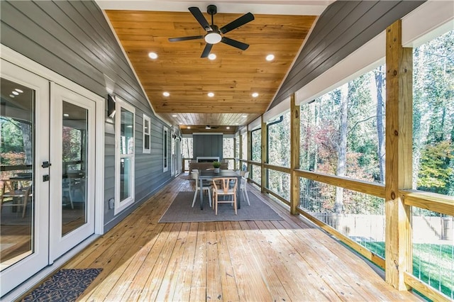 unfurnished sunroom with wooden ceiling, ceiling fan, and vaulted ceiling