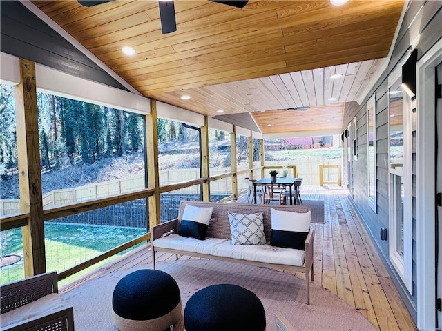 sunroom featuring ceiling fan, vaulted ceiling, and wood ceiling