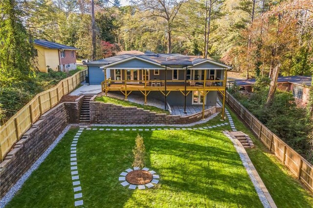 rear view of house featuring a patio and a lawn