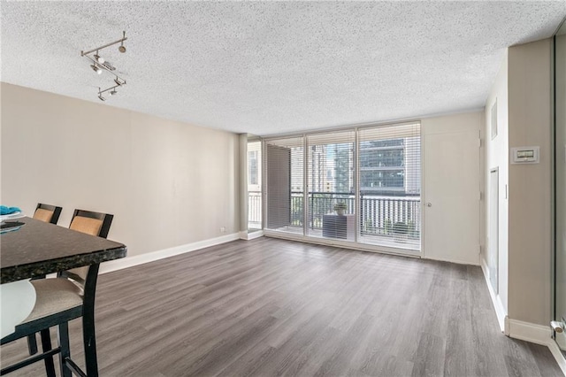 620 Peachtree St NE Unit 911, Atlanta, GA 30308 - unfurnished dining area featuring a textured ceiling, wood finished floors, and rail lighting