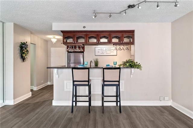 620 Peachtree St NE Unit 911, Atlanta, GA 30308 - bar area with freestanding refrigerator, dark wood-type flooring, and a textured ceiling