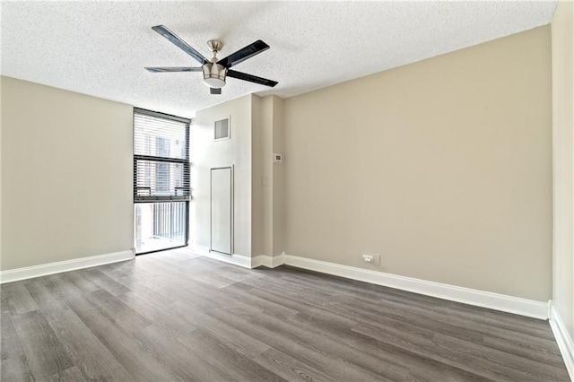 620 Peachtree St NE Unit 911, Atlanta, GA 30308 - spare room featuring dark wood-type flooring, a ceiling fan, and a textured ceiling