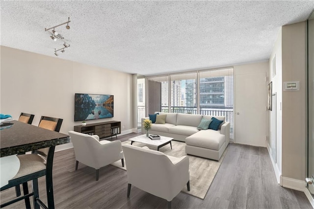 620 Peachtree St NE Unit 911, Atlanta, GA 30308 - living area with a textured ceiling, wood finished floors, and rail lighting