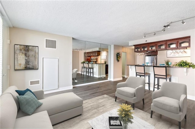 620 Peachtree St NE Unit 911, Atlanta, GA 30308 - living room featuring wood finished floors and a textured ceiling