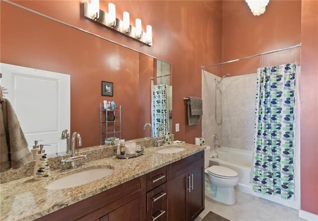 full bathroom featuring double sink vanity, tile flooring, shower / bath combo with shower curtain, and toilet