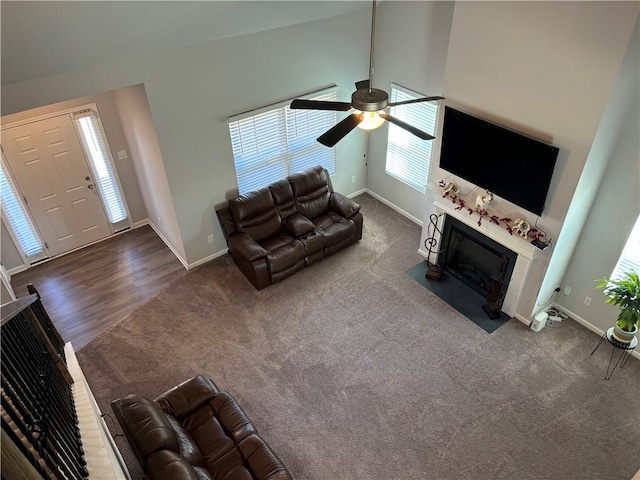 unfurnished living room featuring dark hardwood / wood-style flooring, ceiling fan, and high vaulted ceiling