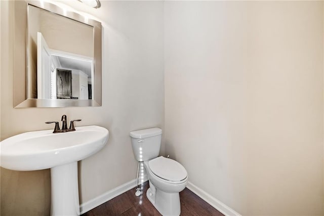 bathroom featuring toilet, hardwood / wood-style flooring, and sink