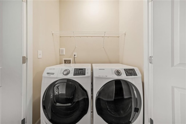 washroom with separate washer and dryer