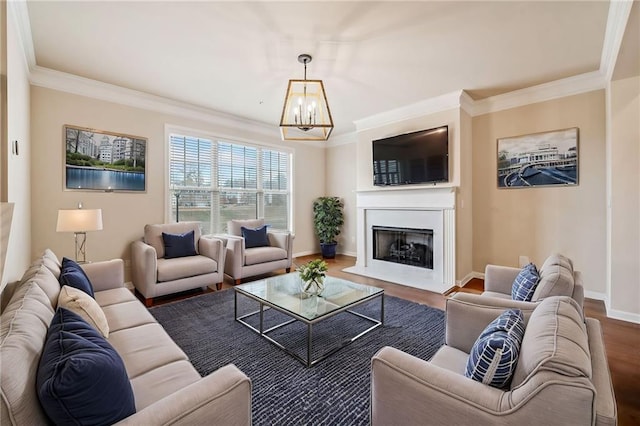 living room with wood-type flooring, crown molding, and an inviting chandelier