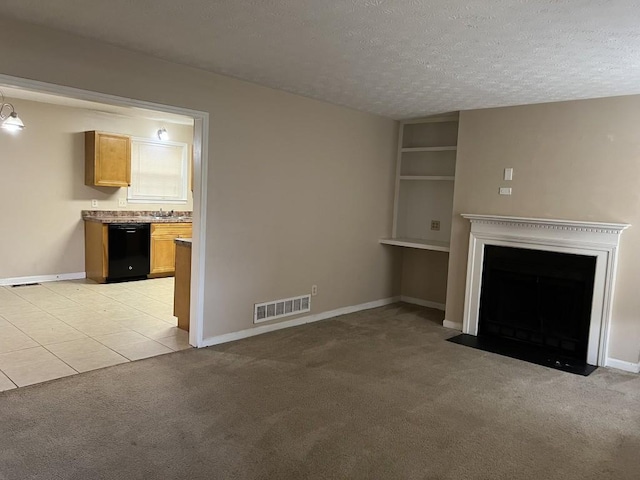 unfurnished living room featuring a textured ceiling and light colored carpet