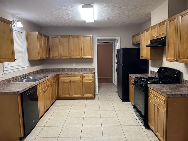 kitchen featuring black appliances, sink, a textured ceiling, and light tile patterned floors