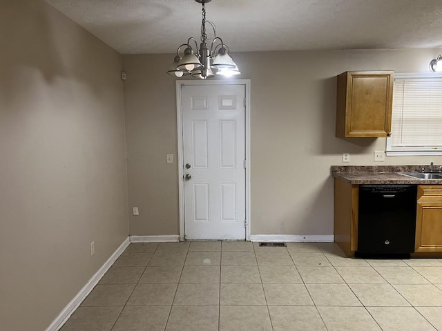 kitchen with black dishwasher, light tile patterned floors, pendant lighting, sink, and a chandelier