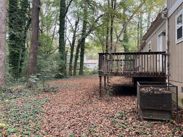 view of yard featuring a wooden deck and central AC