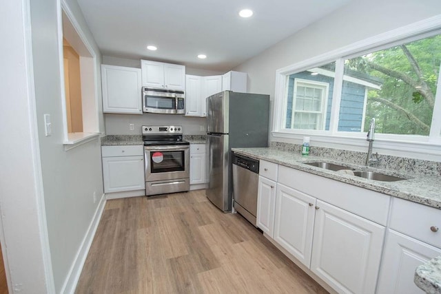 1402 Elm St, Lagrange, GA 30240 - kitchen with light wood-style floors, a sink, appliances with stainless steel finishes, and white cabinets