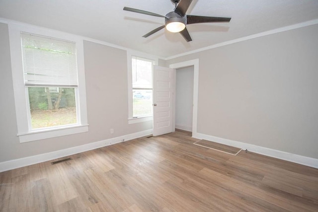 1402 Elm St, Lagrange, GA 30240 - spare room with visible vents, light wood-style flooring, baseboards, and crown molding