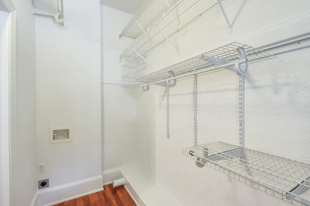 walk in closet featuring dark wood-type flooring