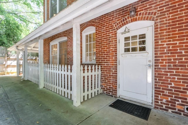 property entrance featuring brick siding