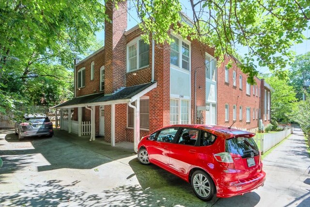 view of property exterior featuring brick siding and a chimney