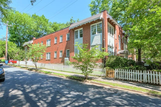 view of building exterior with a fenced front yard
