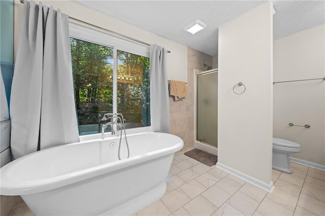 1438 Heritage Glen Dr, Marietta, GA 30068 - bathroom with marble finish floors, a stall shower, a freestanding tub, and a textured ceiling