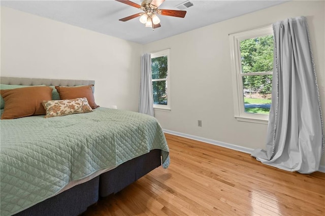 1438 Heritage Glen Dr, Marietta, GA 30068 - bedroom with light wood-style flooring, multiple windows, and a ceiling fan