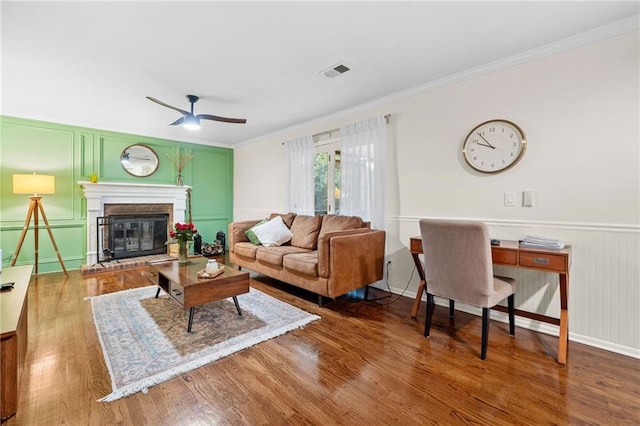 1438 Heritage Glen Dr, Marietta, GA 30068 - living room with a decorative wall, wood finished floors, ceiling fan, crown molding, and a fireplace