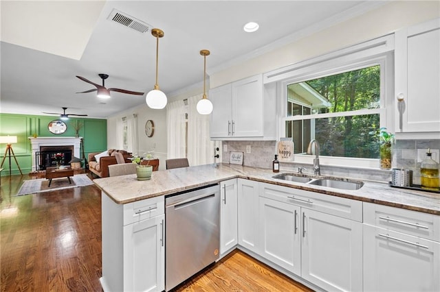 1438 Heritage Glen Dr, Marietta, GA 30068 - kitchen with dishwasher, ceiling fan, crown molding, a brick fireplace, and white cabinets