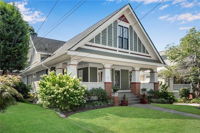 view of front of home with covered porch and a front yard