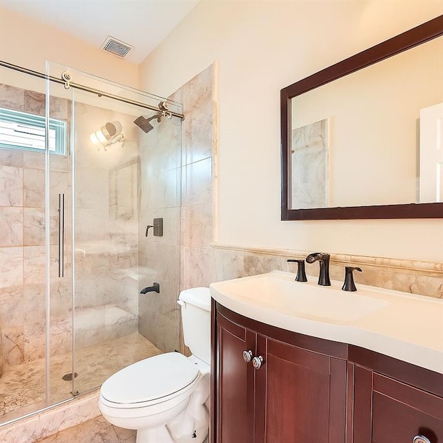 1713 Paramore Pl NE, Marietta, GA 30062 - full bathroom with vanity, a shower stall, tile walls, and wainscoting