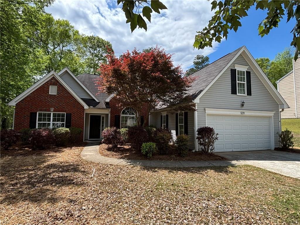 1221 St James Pl, Loganville, GA 30052 - traditional-style house with brick siding, driveway, and a garage