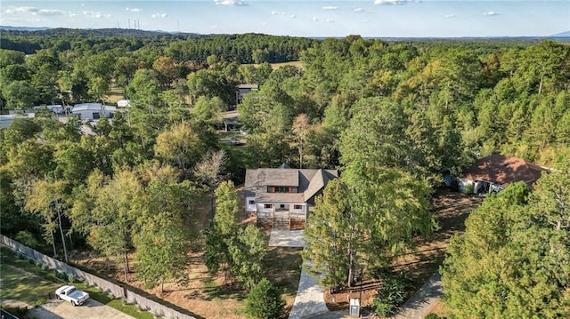 drone / aerial view featuring a forest view