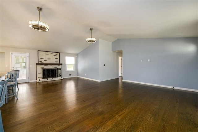 unfurnished living room featuring lofted ceiling, a large fireplace, and dark hardwood / wood-style flooring