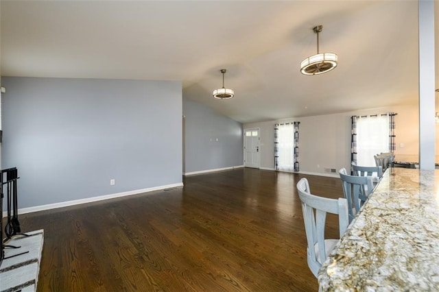 living room featuring vaulted ceiling and dark hardwood / wood-style flooring