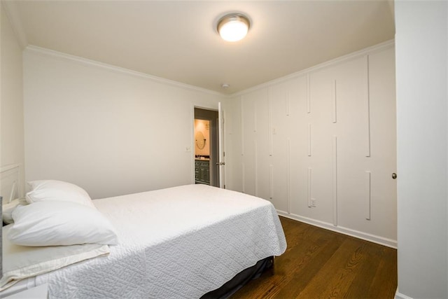 bedroom featuring ornamental molding, a closet, and dark hardwood / wood-style floors