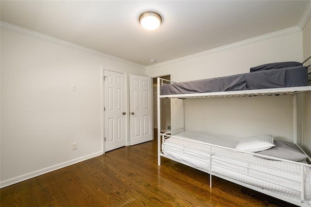 unfurnished bedroom with dark wood-type flooring and ornamental molding